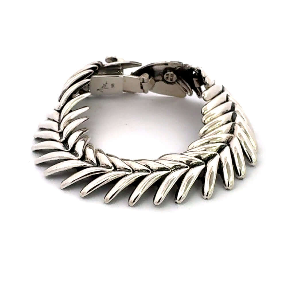 Side view of silver fishbone bracelet showing box clasp detail.