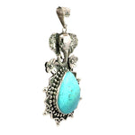 Side angle view showing the raised textured details of the silver elephant motif and high-polish turquoise cabochon setting.