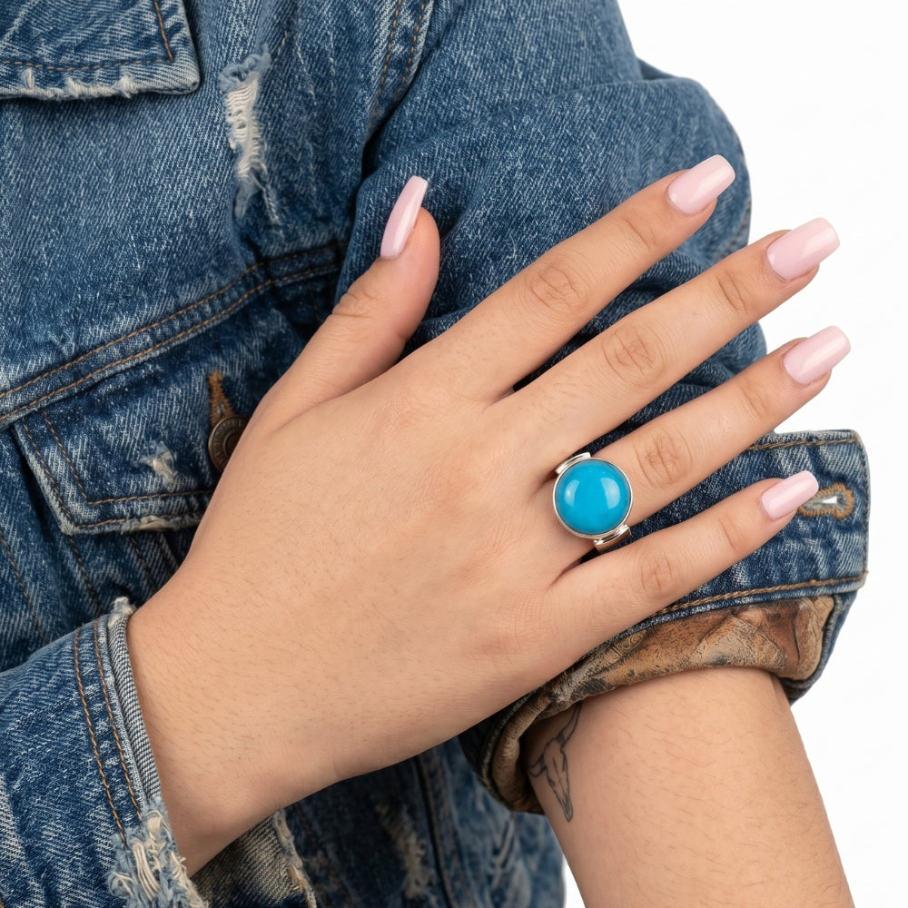 Close-up view of the artisan chunky irregular turquoise ring worn on a hand, illustrating its bold scale and powerful presence against the skin.