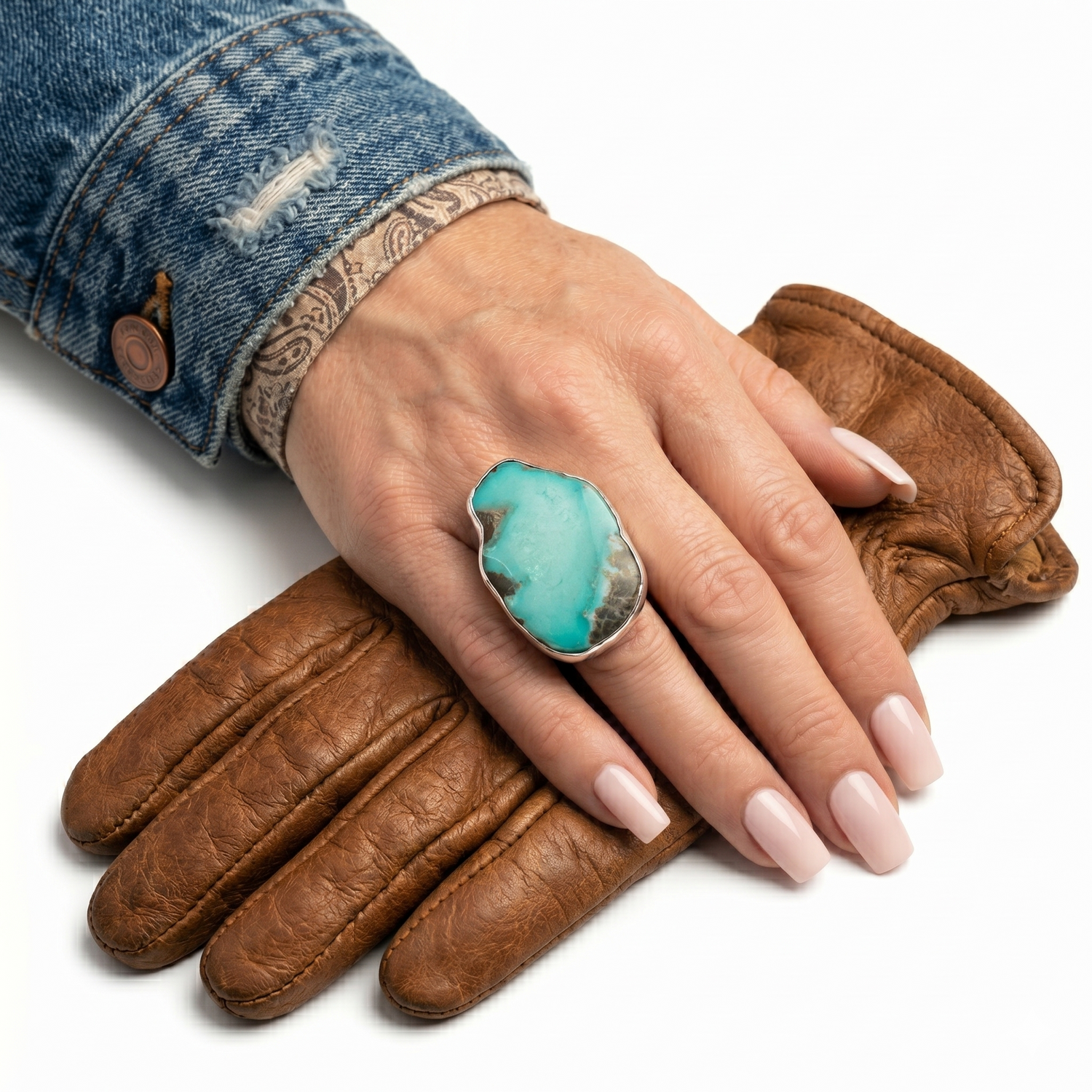 Close-up view of the artisan chunky irregular turquoise ring worn on a hand, illustrating its bold scale and powerful presence against the skin.
