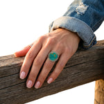 Close-up view of the artisan western silver turquoise ring worn on a finger, illustrating its clean scale and smooth fit against the skin.
