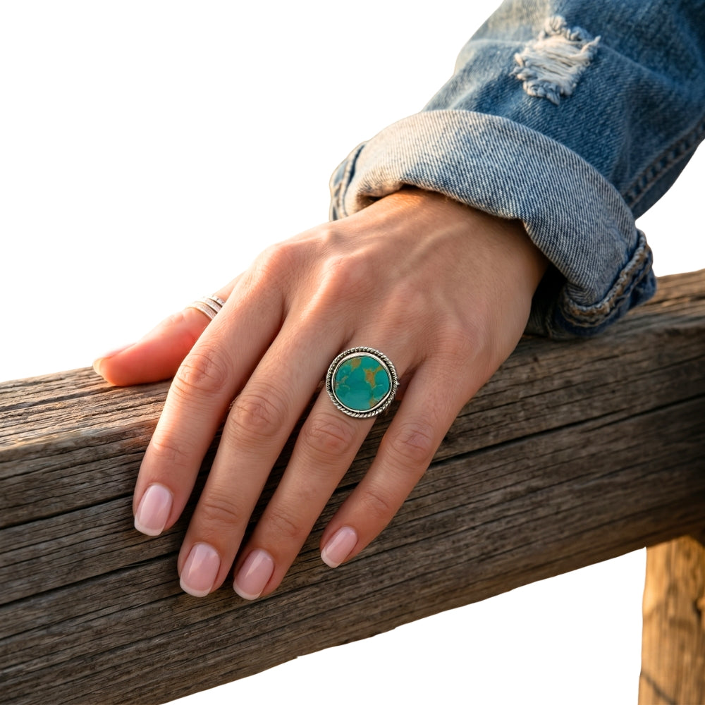 Close-up view of the artisan western silver turquoise ring worn on a finger, illustrating its clean scale and smooth fit against the skin.