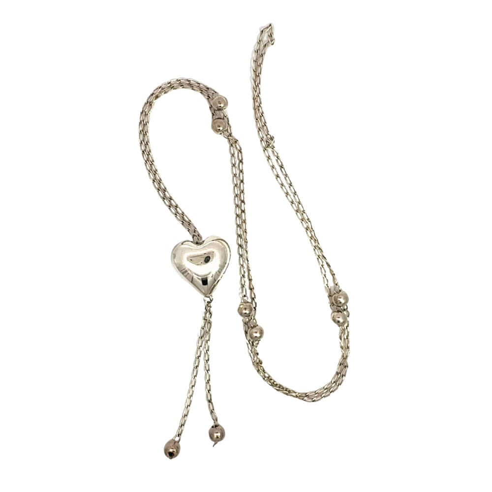 Overhead flatlay displaying the full 76 cm intricate link chain pattern and handcrafted silver spheres.
