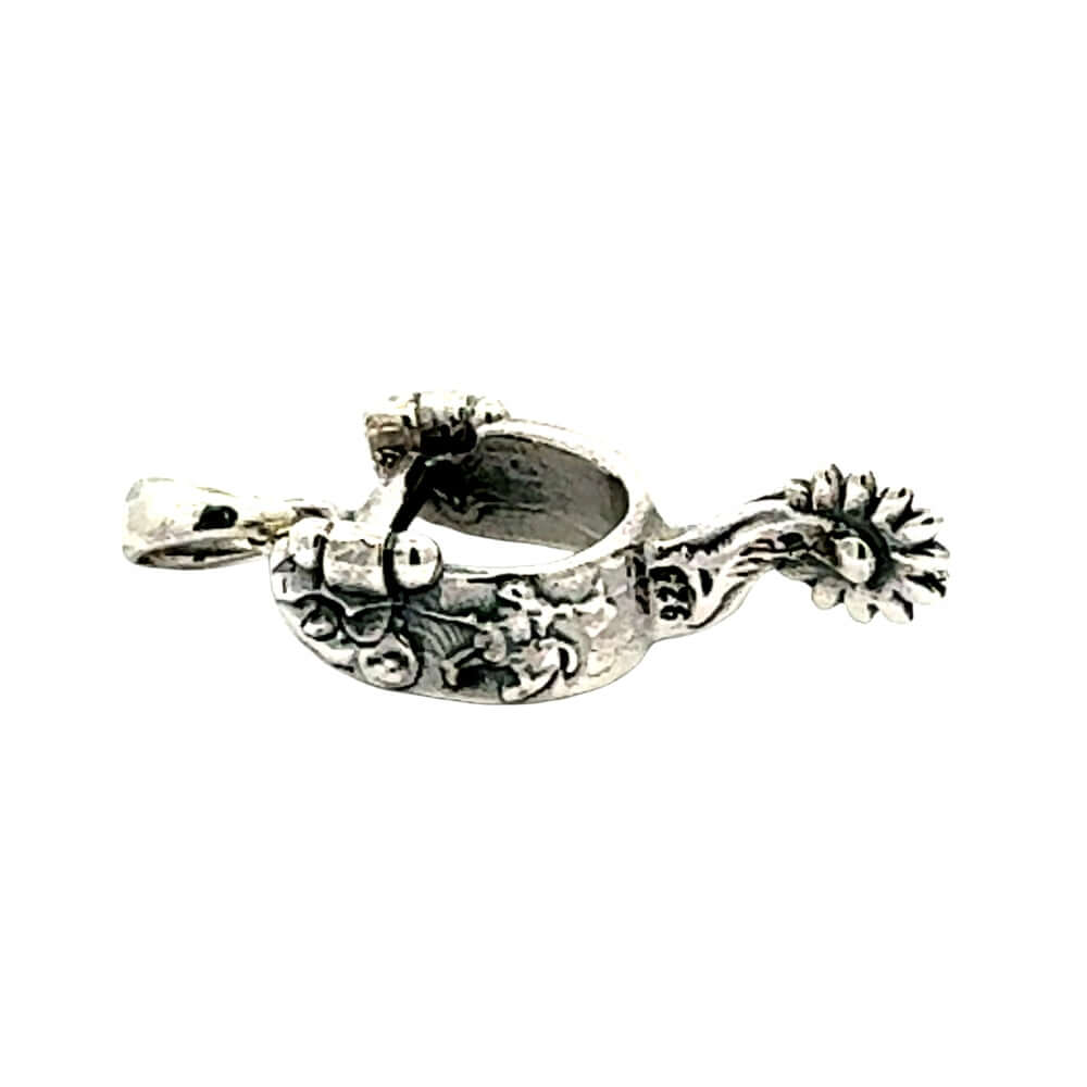 Flat lay perspective of the solid silver spur pendant showcasing its intricate sculptural design from above.