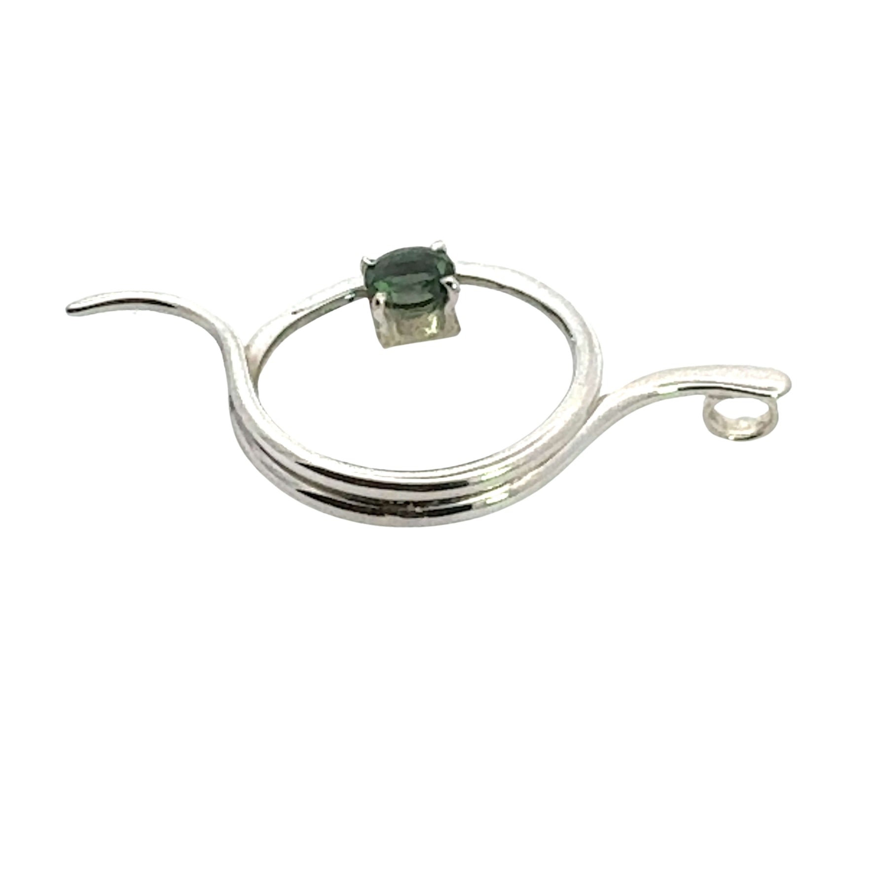 The side of a handmade silver pendant showing the smooth finish and artistic construction.