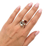 High-purity silver pitcher ring with amber shown on a hand to illustrate its scale and daily wear appeal.