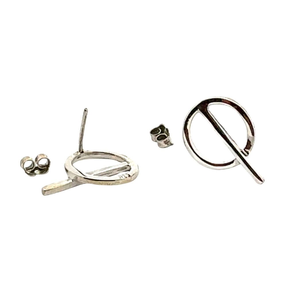 Overhead view of Stuart Alarcón silver post earrings with backs showing professional handcrafted finish