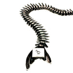 Close-up detail of the underside of the silver fishbone tail, stamped with the signature Molina "m." maker's mark and .925 sterling silver purity stamp.