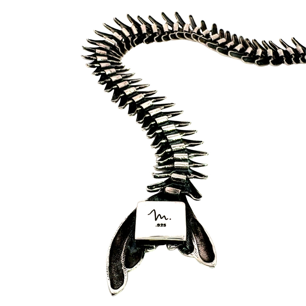 Close-up detail of the underside of the silver fishbone tail, stamped with the signature Molina "m." maker's mark and .925 sterling silver purity stamp.
