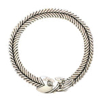 Authentic Taxco sterling silver fishbone collar necklace from the Molina workshop, arranged in a perfect circle against a white background.