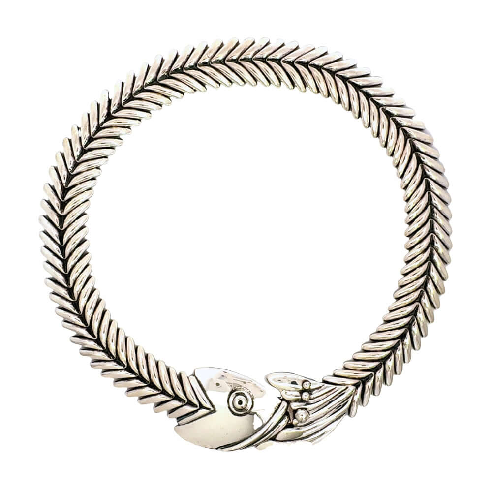Authentic Taxco sterling silver fishbone collar necklace from the Molina workshop, arranged in a perfect circle against a white background.