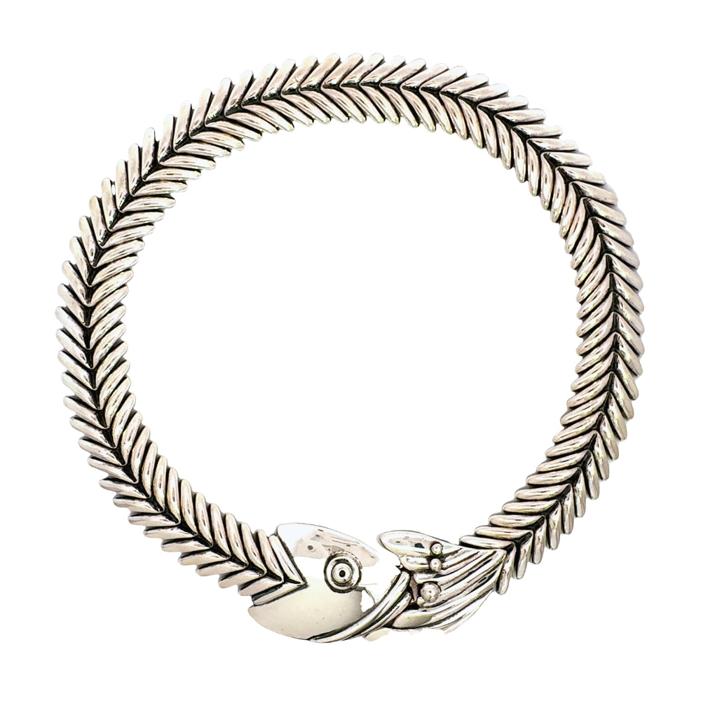 Authentic Taxco sterling silver fishbone collar necklace from the Molina workshop, arranged in a perfect circle against a white background.