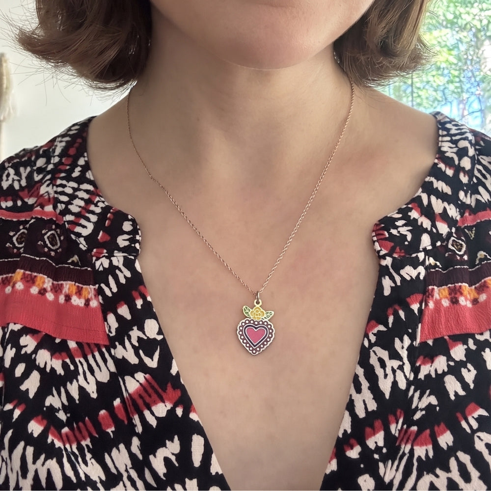 Woman wearing a sterling silver enamel corazón heart pendant necklace