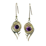 Pair of 925 sterling silver flame earrings with round purple amethyst center stone on white background.