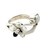 Detailed view of the textured silver petals and 925 hallmark on a handmade ring.