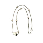 Silver necklace with a heart pendant on a white background