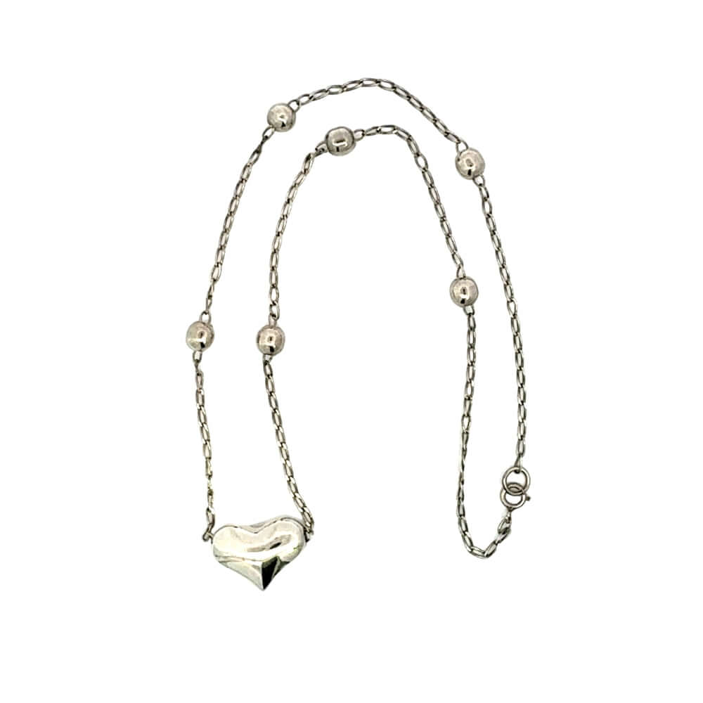 Silver necklace with a heart pendant on a white background