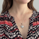 Woman wearing a sterling silver maguey agave plant pendant necklace