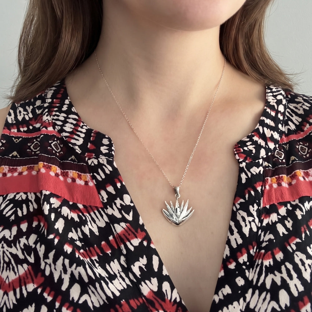Woman wearing a sterling silver maguey agave plant pendant necklace