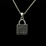 Sterling silver woven market bag pendant necklace with handle, black background