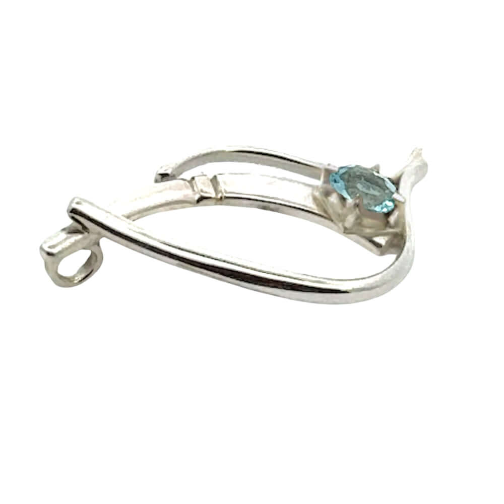 Detailed side view showing the craftsmanship of a handmade silver pendant