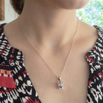 Woman wearing a sterling silver pig pendant necklace