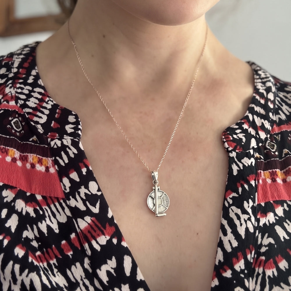 Woman wearing a sterling silver tortillero pendant necklace