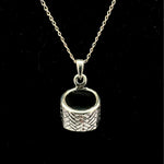 Sterling silver woven basket pendant necklace with black enamel interior, black background