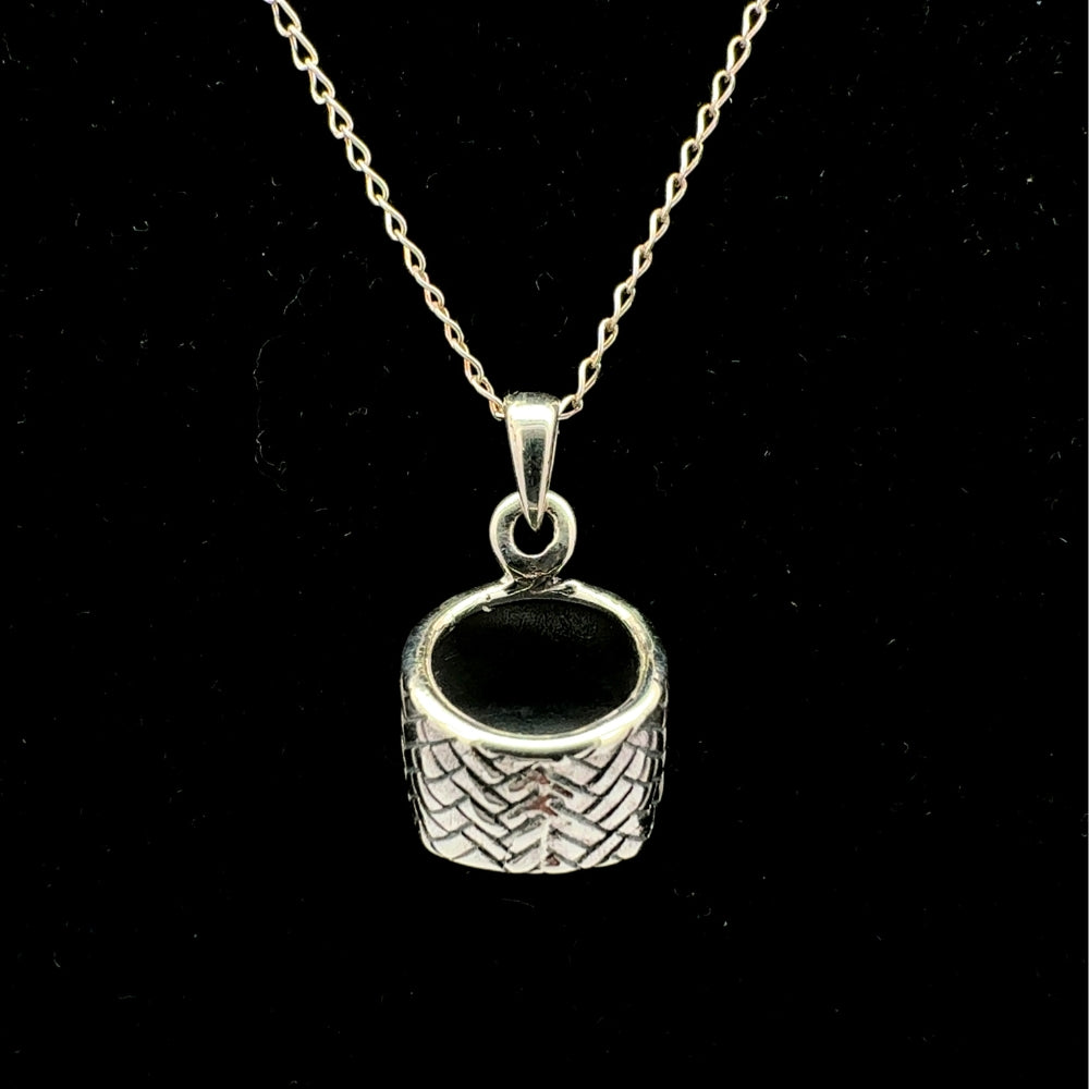 Sterling silver woven basket pendant necklace with black enamel interior, black background