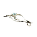 Side profile of a handcrafted sterling silver and blue topaz necklace pendant