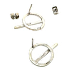 Dynamic shot of sterling silver circle and line earrings showcasing the artistic repeating elements