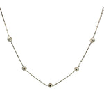Silver necklace with small silver beads on a white background