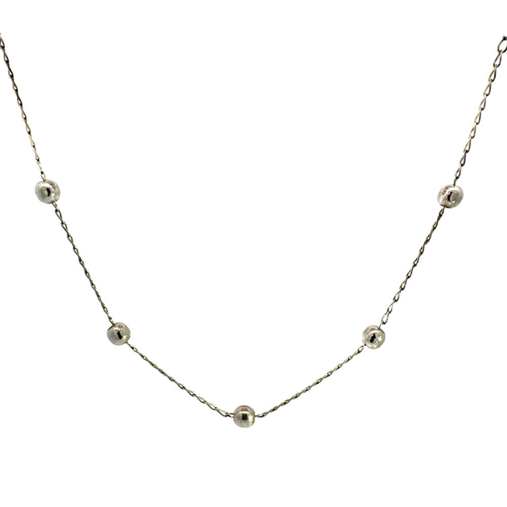 Silver necklace with small silver beads on a white background