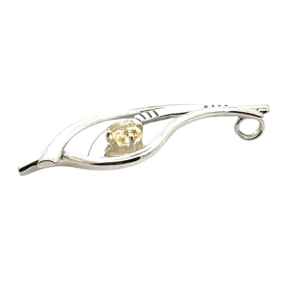 Side profile of a master-crafted silver pendant showing the elevated setting of the citrine stone.