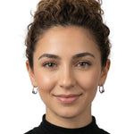 Woman wearing delicate Taxco silver hoops with amethyst to show the graceful scale and fit