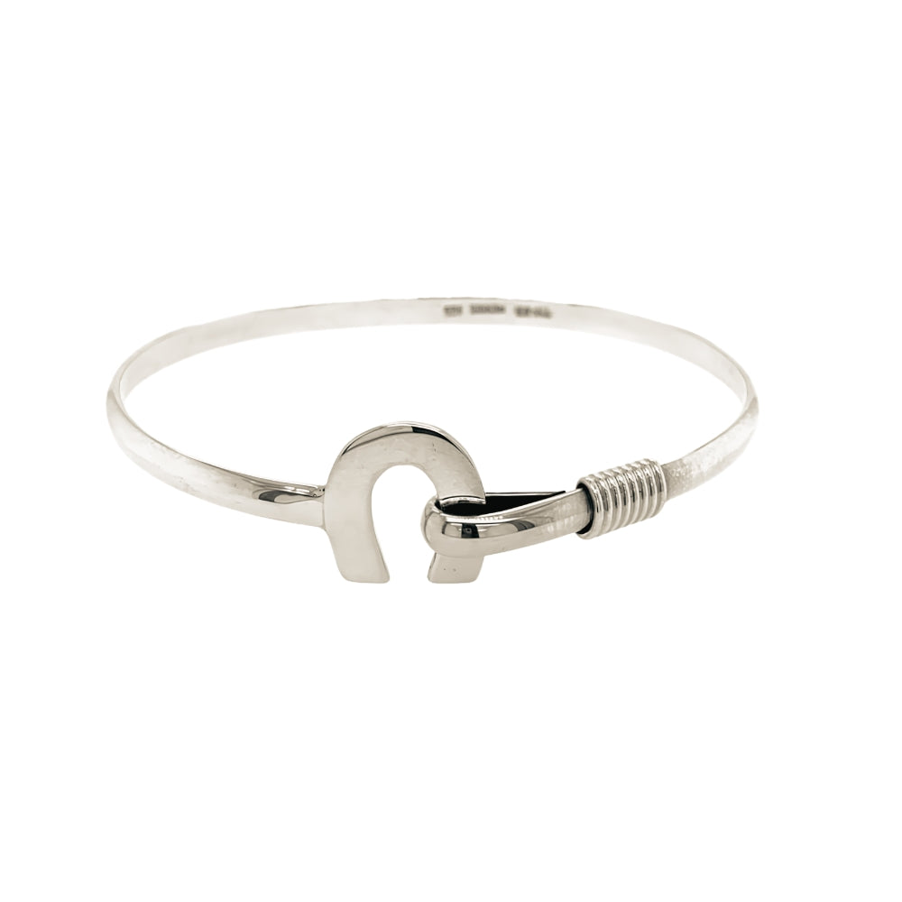 Front view of a handmade 925 sterling silver bangle featuring a detailed horseshoe centerpiece motif.