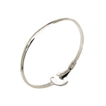 Silver bangle with a clasp on a white background