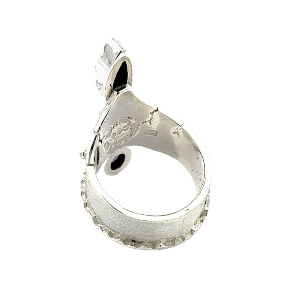 Alternative side profile view showcasing the molten silver border detail and secure gemstone settings.