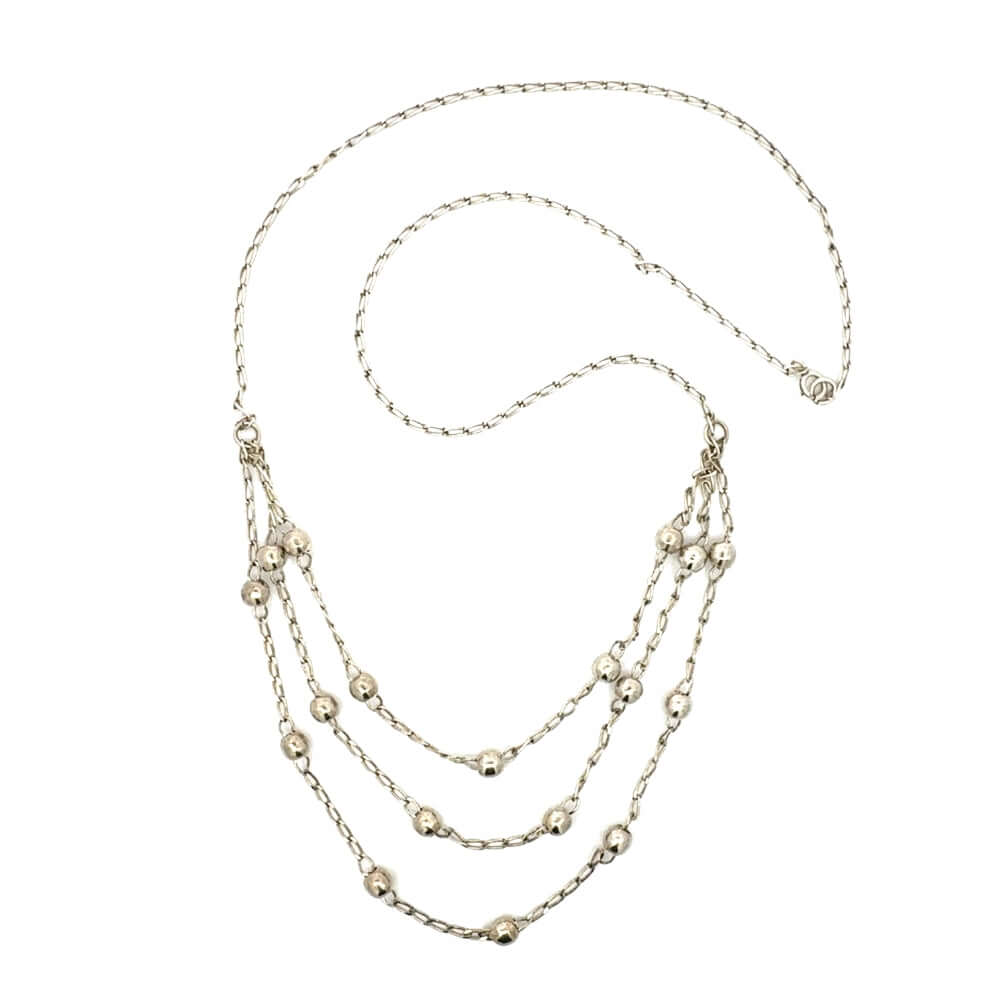 Full view of the 24-inch tiered sterling silver chain necklace laid flat
