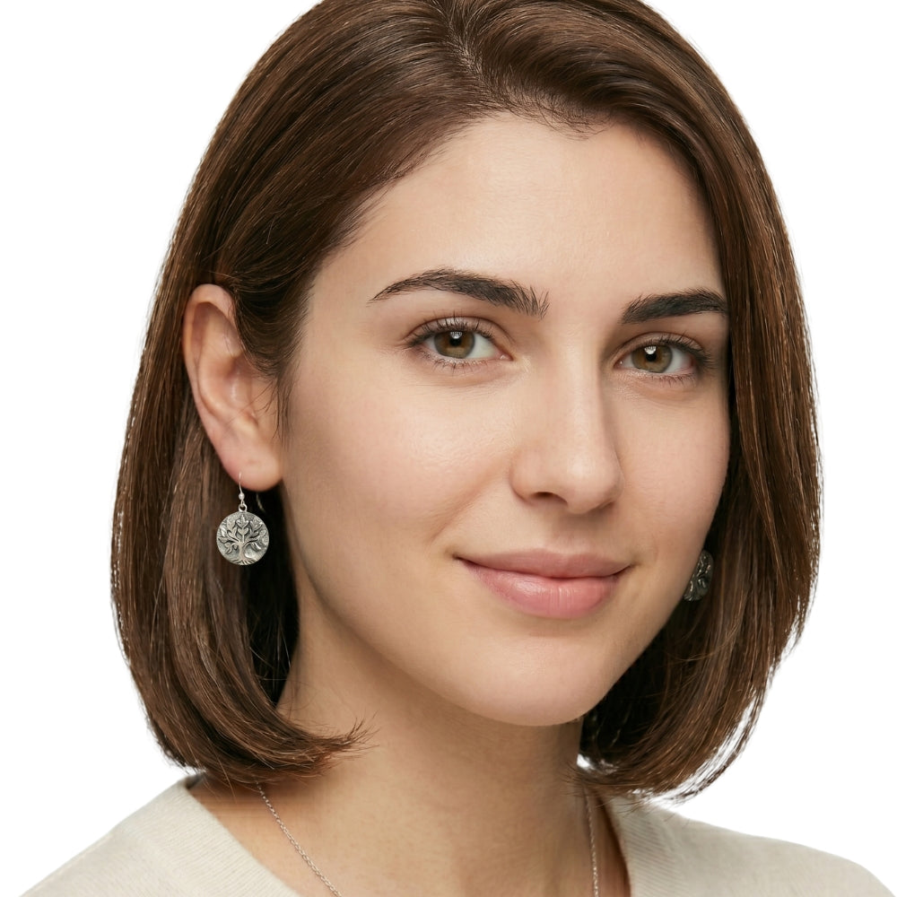 A woman with a natural elegant style wearing the handcrafted silver tree of life earrings for an effortless look