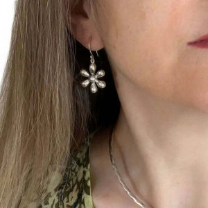 Flower Earrings In Silver with model - Nueve Sterling