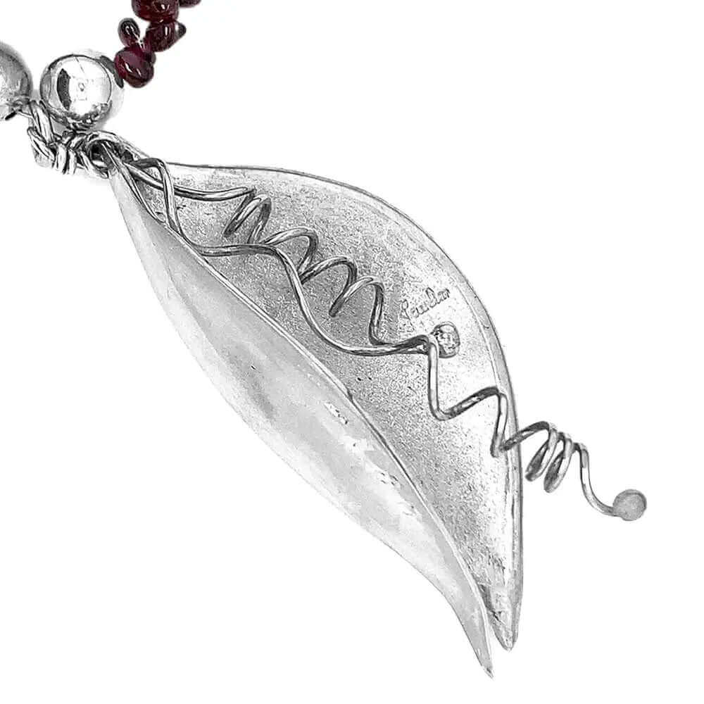 Side view of silver pendant showing stamps