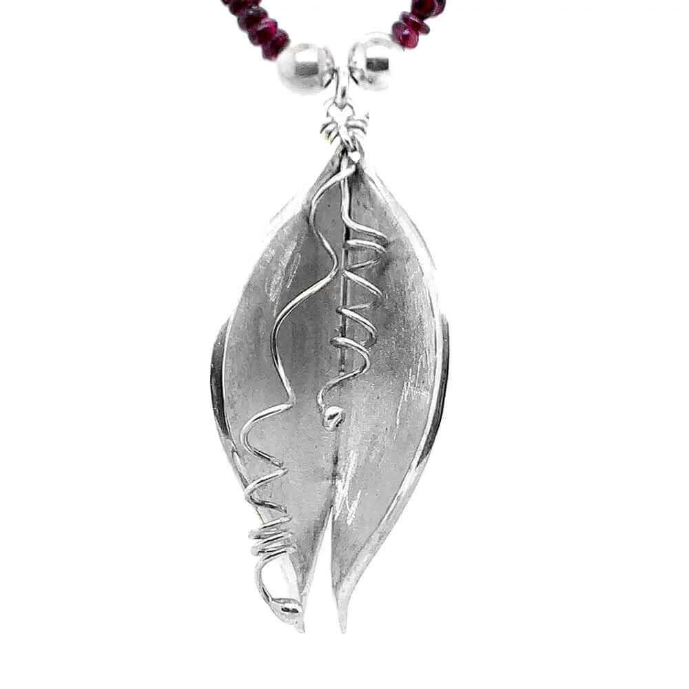 Close up of silver pendant of a Garnet Silver Necklace