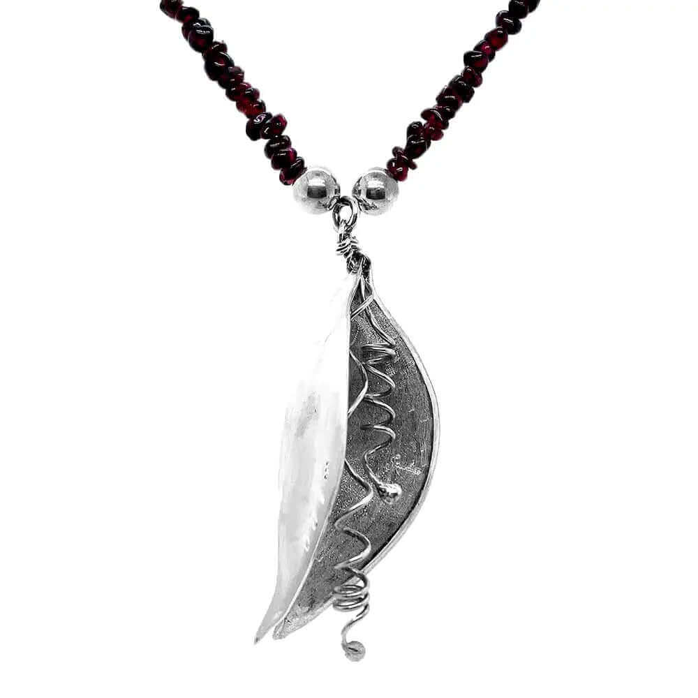 Close up of side pendant and garnet stones necklace
