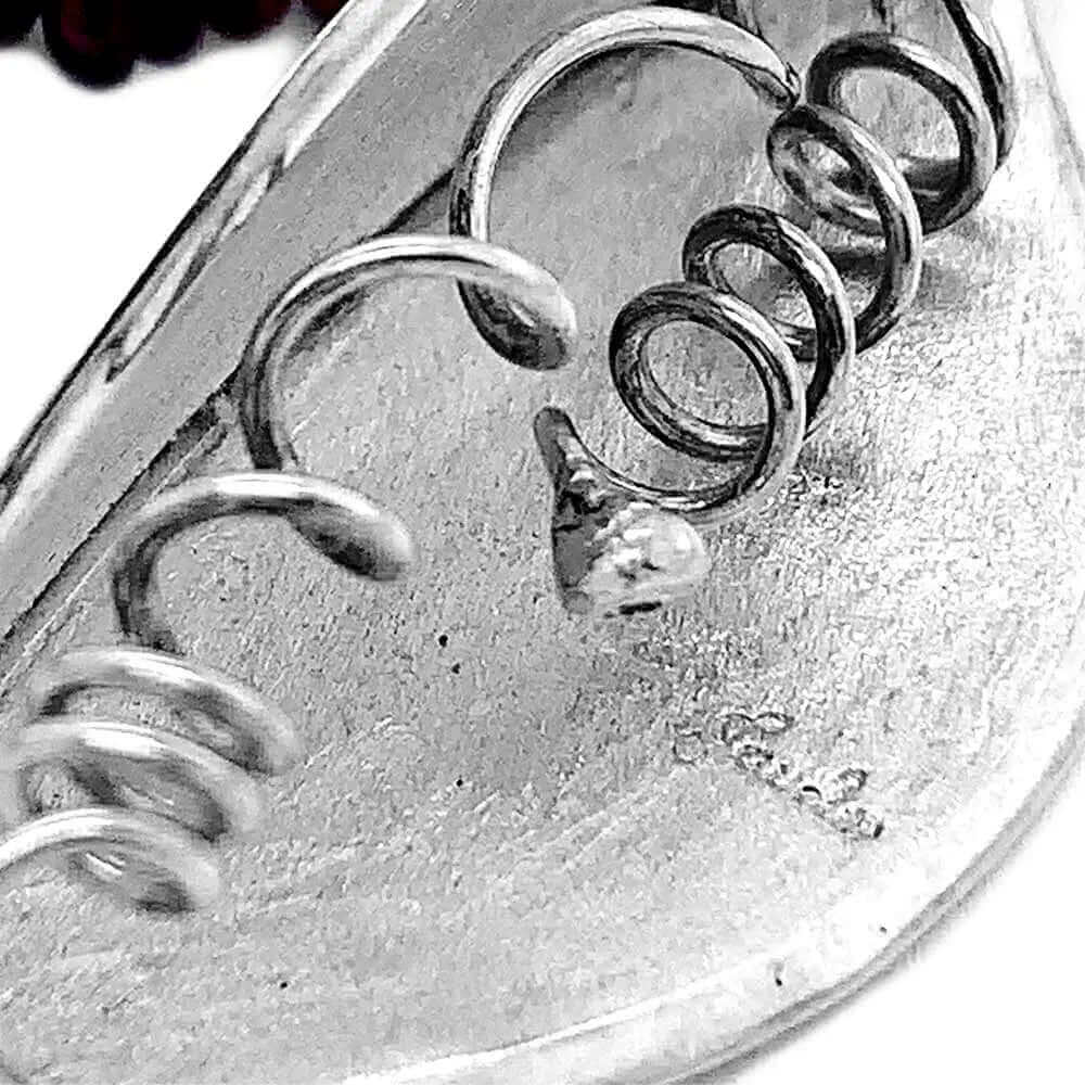 Close up of stamp in a silver piece