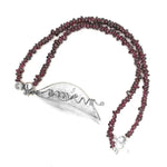 Garnet necklace with a silver pendant from top view
