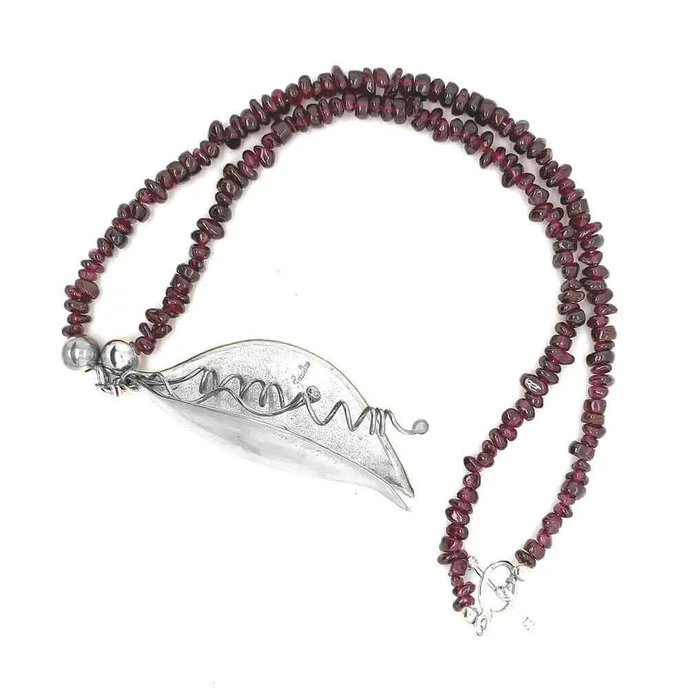 Garnet necklace with a silver pendant from top view
