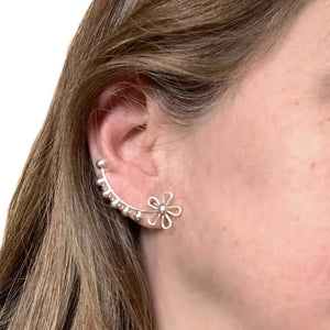 Long-Flower-Silver-Climber-Earrings-with-model-Nueve-Sterling