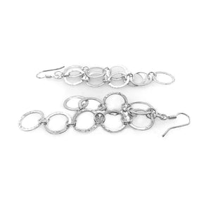 Long Hammered Circles Silver Earrings flat - Nueve Sterling