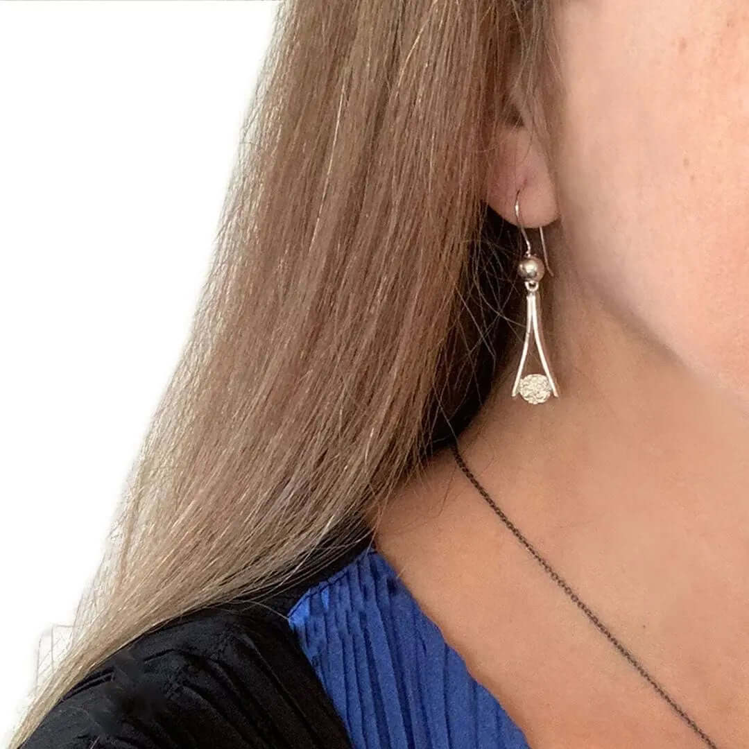  Long Stylized Earrings With Circle In Silver with model - Nueve Sterling
